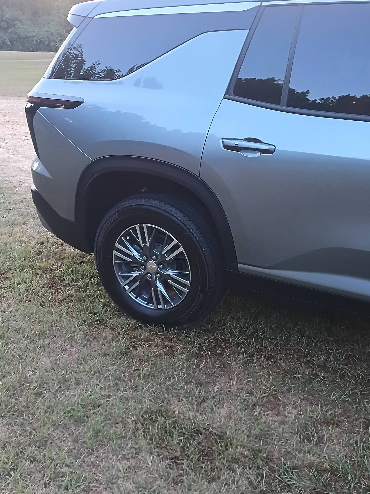 Detailed silver Chevrolet SUV rear wheel and panel