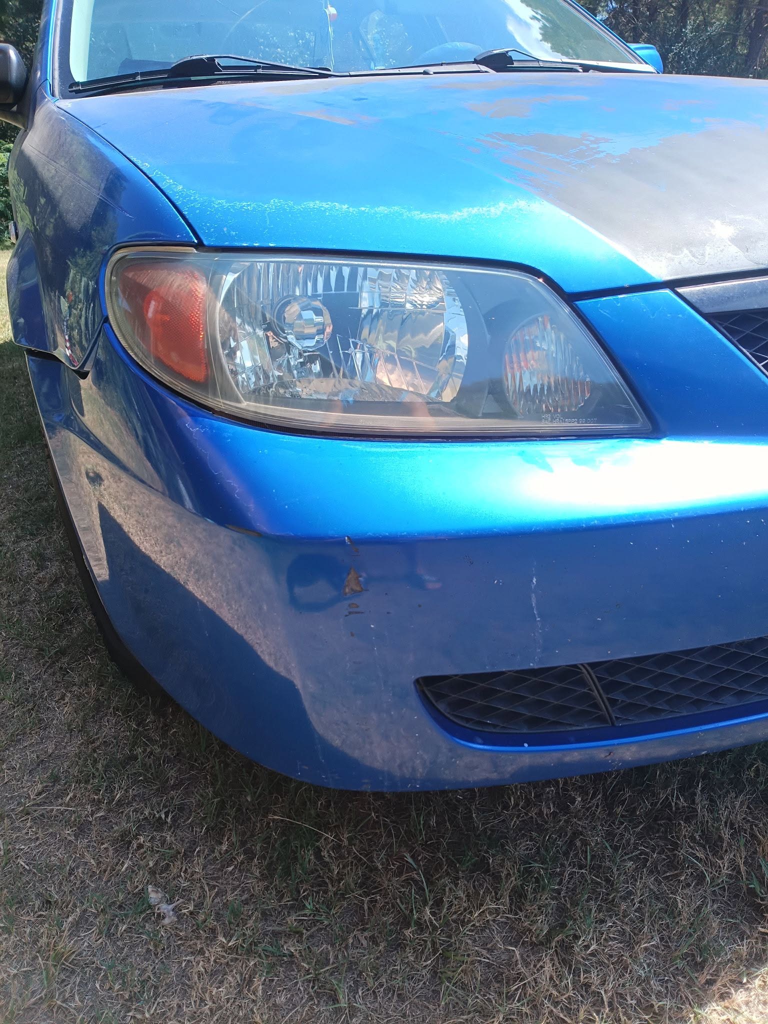 Restored headlight on a blue vehicle